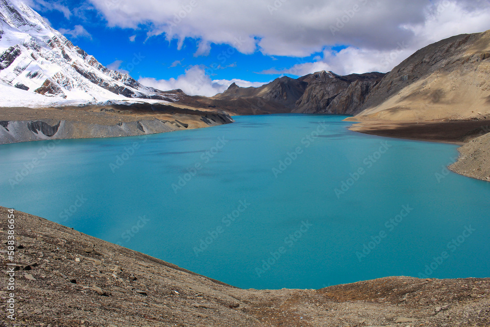 The deep luminescent blue of one of the highest lakes in the world - Tilicho Lake at 4910 meters above sea level, just below Tilicho peak, on the Annapurna circuit trek