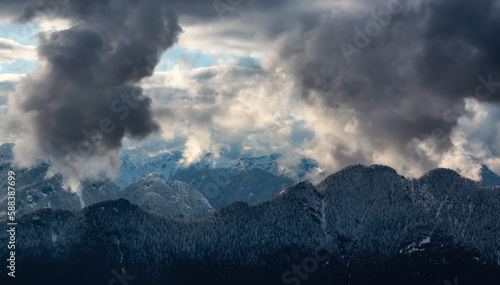 Aerial View of Canadian Mountain Landscape covered in snow and clouds. Nature Background. near Vancouver, BC, Canada.