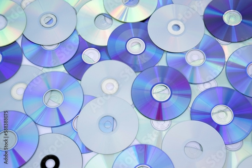 Lots of old CDs are laid out as a background. #588388075
