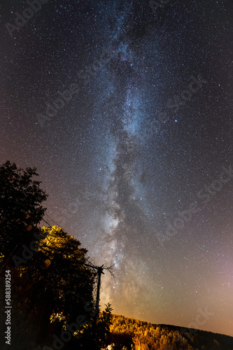 milky way and a village under the starry sky