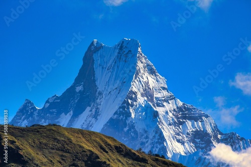 Magnificient Mount Machhapuchhare at 6993 meters rises over the lower villages on the trek towards Annapurna Base camp trek