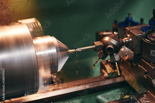 Photography a machine that is working on a piece of metal