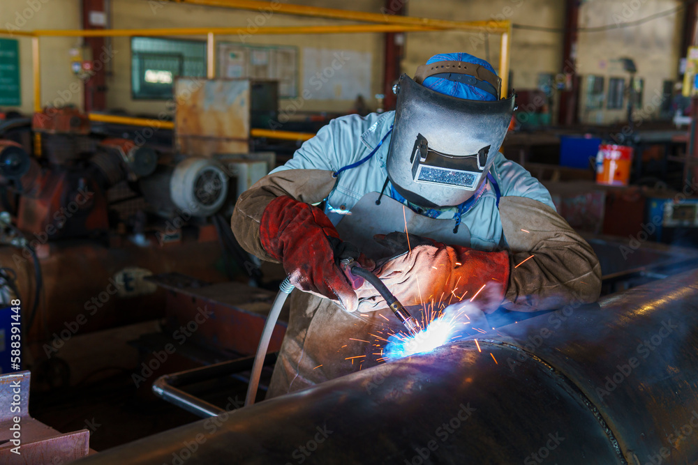 Welder is welding added joint a pipe carbon for steel structure work