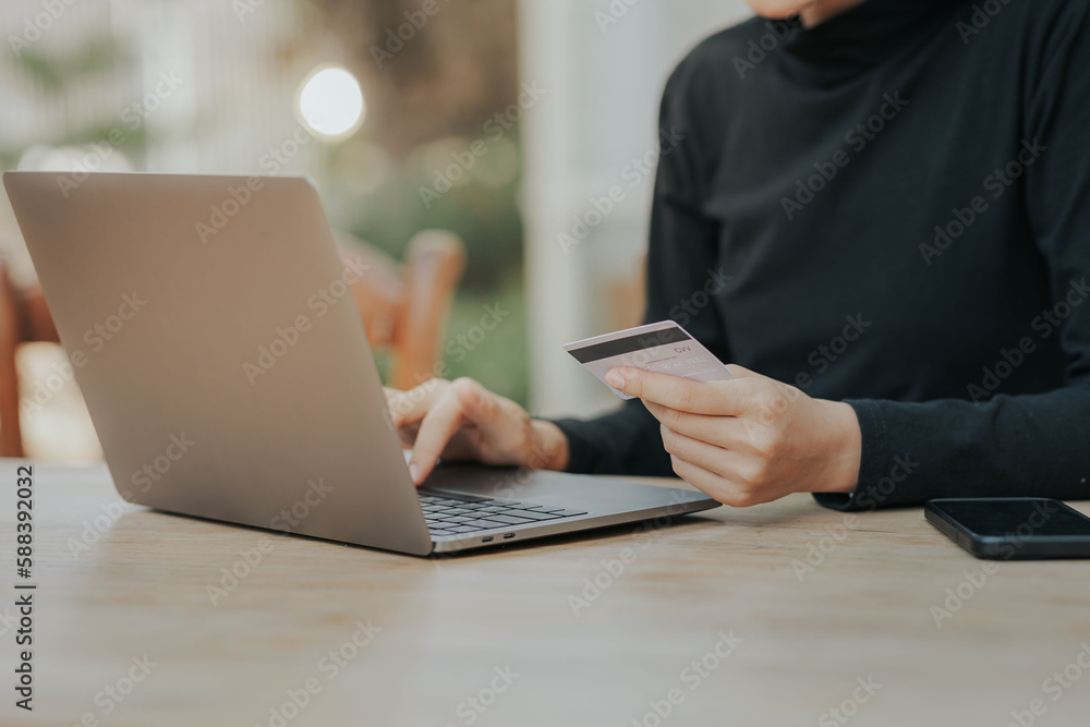 Close up of woman hand holding credit card online payment. Close up of woman hand holding credit card online payment.