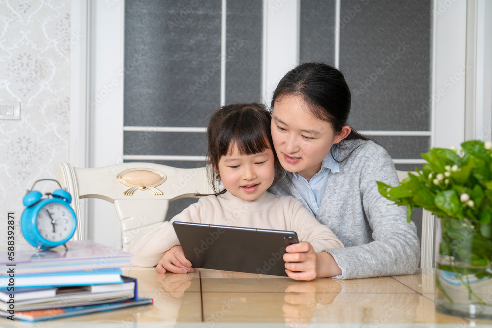 Mom and daughter learn online classes together Mom and daughter learn online classes together