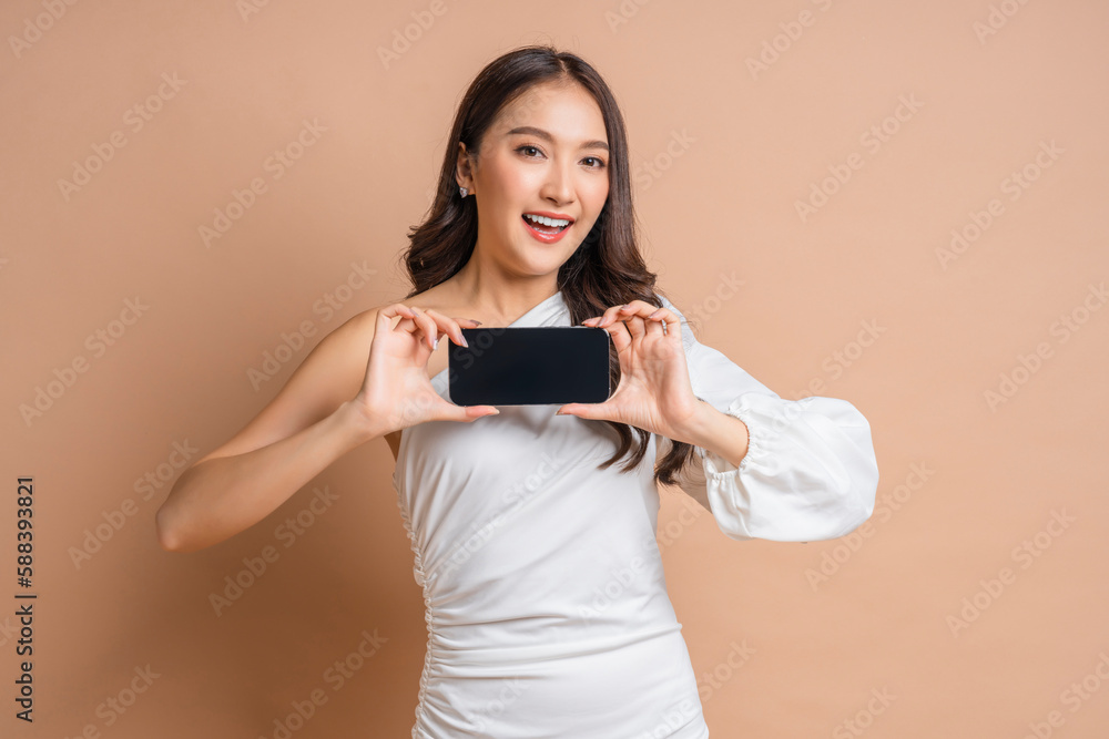 Naklejka premium carefree business smart attractive asian woman in well dress hand showing present blank smartphone to camera portrait shot,cheerful asia female holding smartphone laugh smile friendly warm welcome