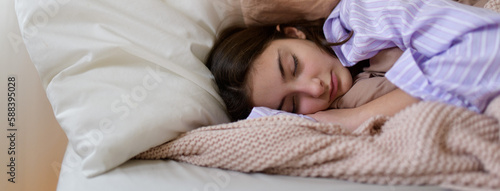Bild auf Leinwand Close-up of teenage girl sleeping in her bed.