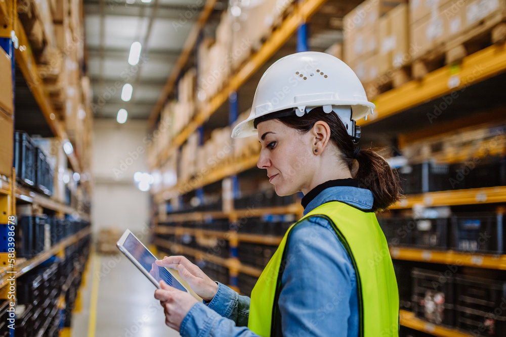 Warehouse female worker checking up stuff in a warehouse. Warehouse female worker checking up stuff in a warehouse.