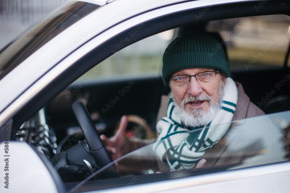 Angry senior man driving a car, close up. Angry senior man driving a car, close up.