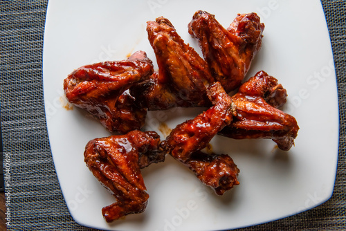 Chicken BBQ Wings isolated on wooden board top view of fastfood