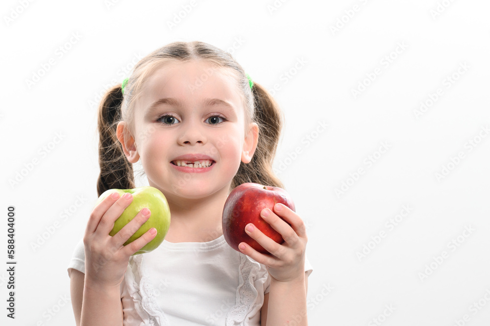 On a white background, the girl holds two green and red apples in her hands On a white background, the girl holds two green and red apples in her hands