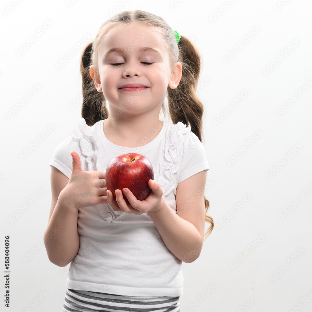 Red apple and little girl, portrait of a child on a white background Red apple and little girl, portrait of a child on a white background
