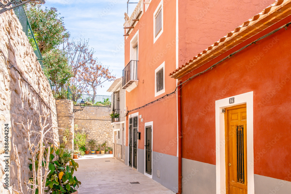 View to beautiful Villajoyosa street with multi-colored houses. Villajoyosa - coastal town in Alicante Province, Valencian Community, Spain, by Mediterranean Sea