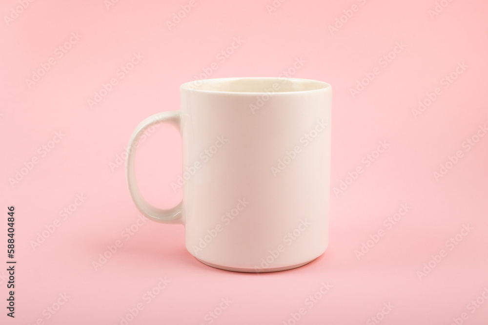 White ceramic cup on a pink background. White ceramic cup on a pink background.