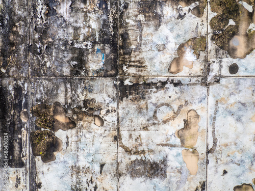  Background from a shabby wall. Old white cracked tiles. Blackened tiles. After the fire.