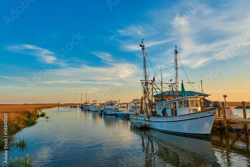 Картината върху платно Sunset with shrimp boats along a dock at Tybee Island, Ga.