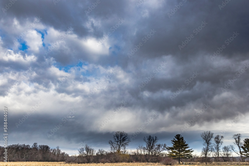 Dramatic spring storm clouds and a rural landscape.