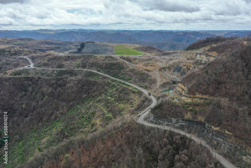 Roads snaking along a mountain with a mine in the distance