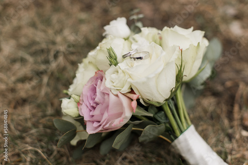 wedding bouquet of the bride with wedding rings