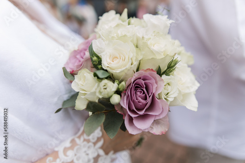 the bride in a wedding dress holds a bouquet of flowers in her hands