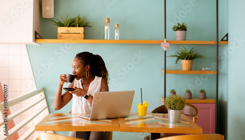 Young black woman drinking ...