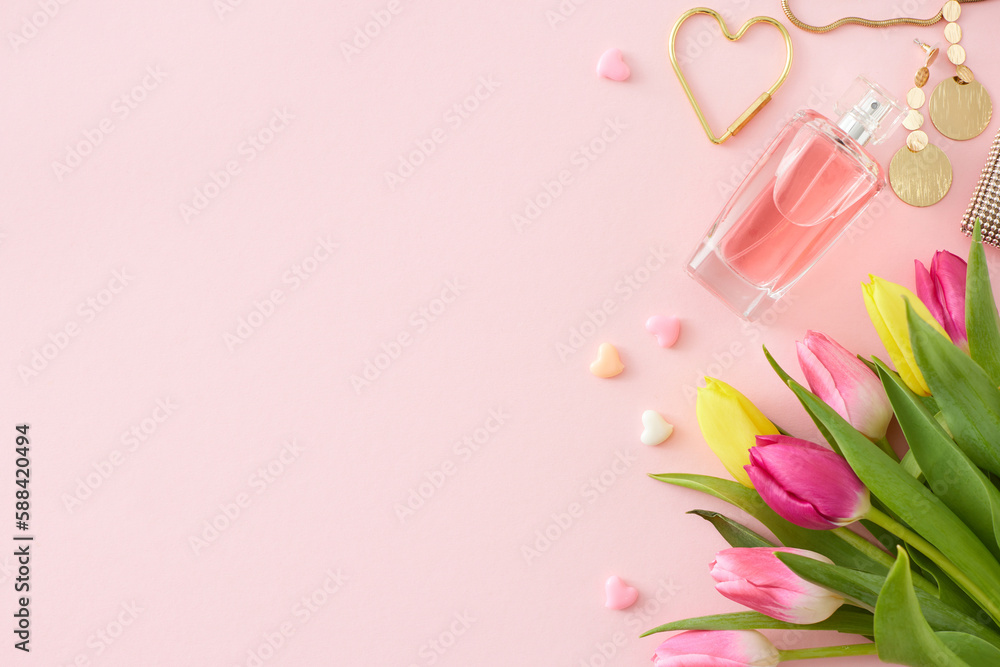 Women's Day concept. Top view photo of bunch of colorful tulips perfume bottle bijouterie earrings and hearts baubles on pastel pink background with copy space