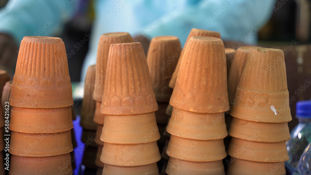 A kulhar or kulhad cup (traditional handle-less clay cup) from India filled with hot Indian tea. A kulhar or kulhad cup (traditional handle-less clay cup) from India filled with hot Indian tea.