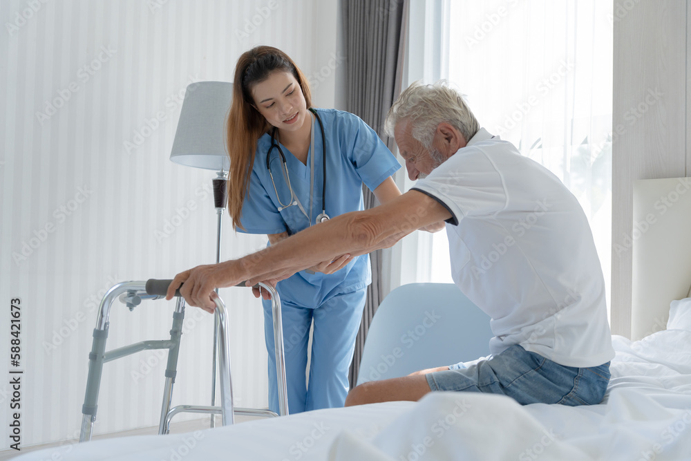 Fototapeta premium Elderly man talk to doctors and nurses in the hospital. senior male happy after receiving treatment and care and practice walk from a professional doctor. health care, physical therapy, nursing home