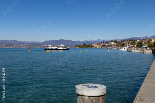 Sirmione, Lake Garda, Italy - 28 March 2023 Ferry arrives at port and harbour of Sirmione