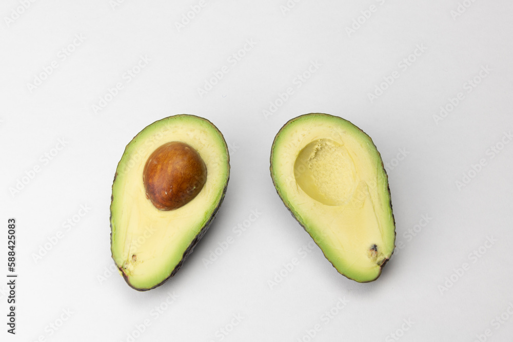 Cut in half (opened) Avocado isolated on white Background. 