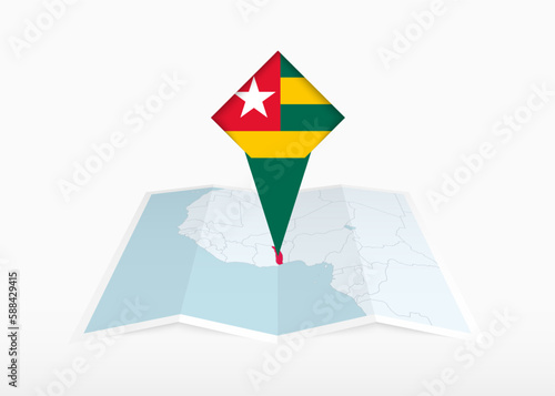 Togo is depicted on a folded paper map and pinned location marker with flag of Togo.