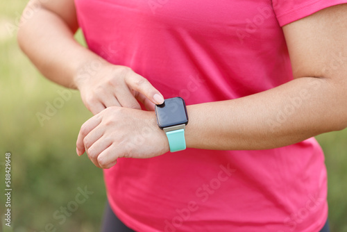 Woman hands setting smart watch. Technology and people concept