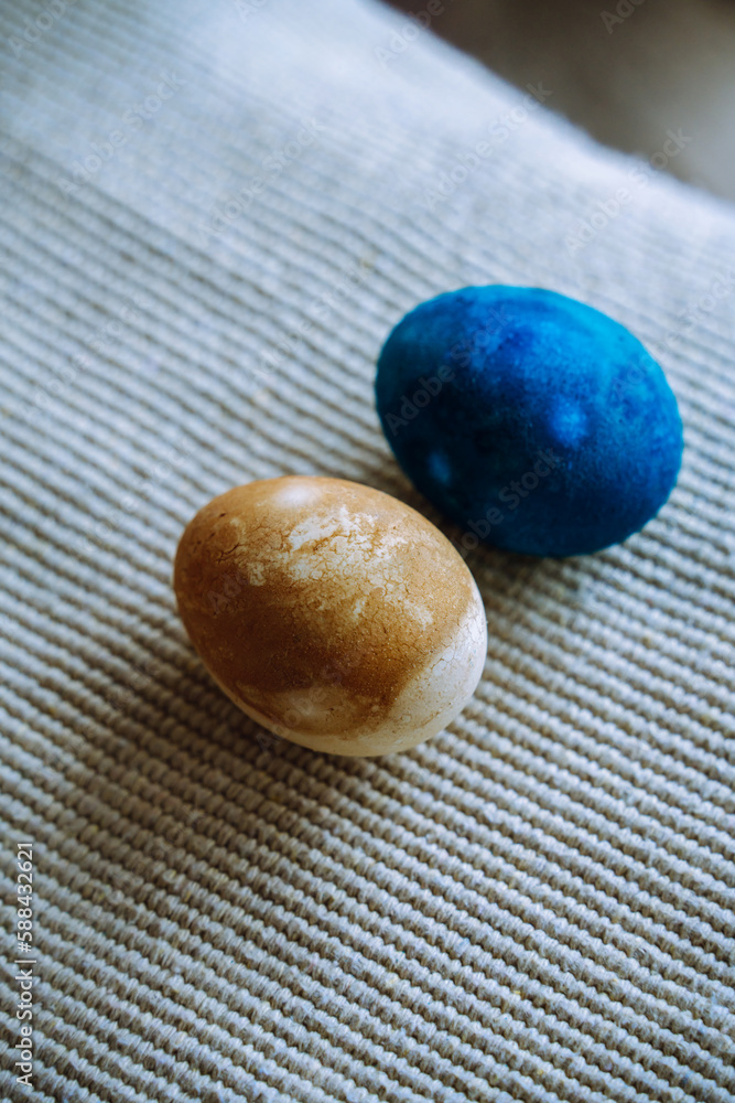 Two dyed easter eggs closeup: golden and blue cosmic dyed Two dyed easter eggs closeup: golden and blue cosmic dyed