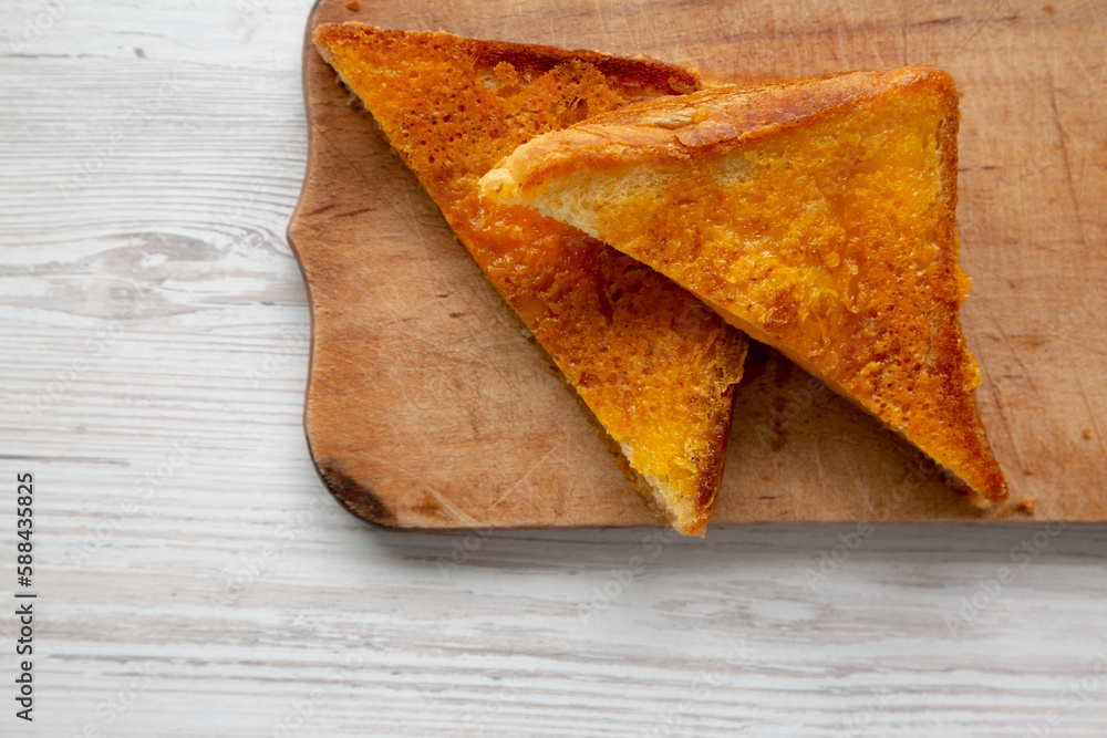 Homemade Inside-Out Grilled Cheese Sandwich on a rustic wooden board, top view. Flat lay, from above, overhead. Homemade Inside-Out Grilled Cheese Sandwich on a rustic wooden board, top view. Flat lay, from above, overhead.