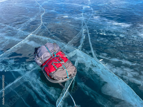 sled dragging on the frozen ice of Lake Baikal. Winter trekking