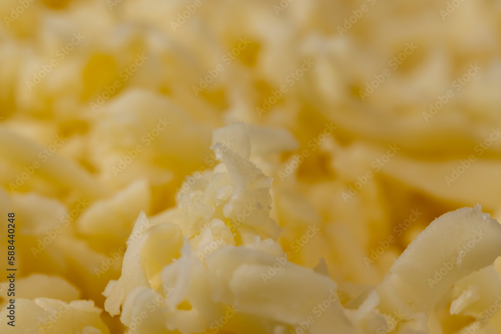 Hard cheese with holes grated into thin small slices Hard cheese with holes grated into thin small slices