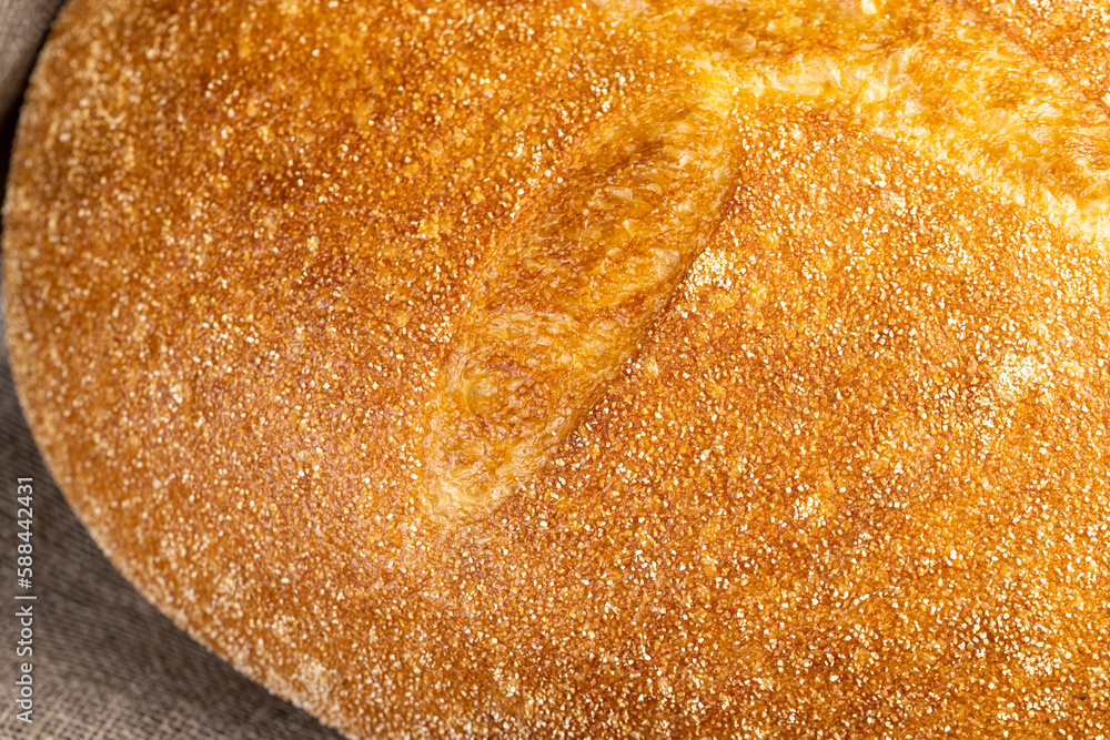 A whole loaf of round-shaped wheat bread