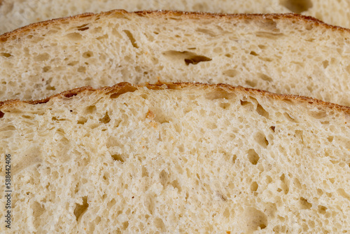 A cut loaf of round-shaped wheat bread