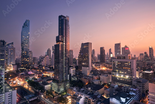 Night view of urban skyline at dusk. Downtown with skyscrapers and modern architecture. Bangkok, Thailand...
