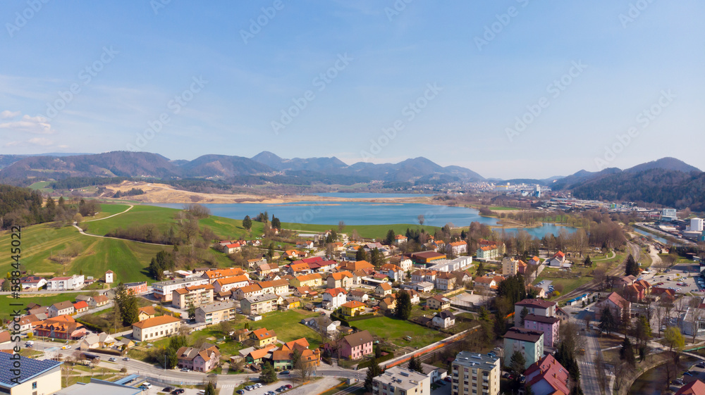 Panorama of lake flooding fields on a sunny day with town near by.