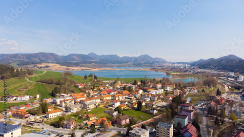 Obraz na płótnie Panorama of lake flooding fields on a sunny day with town near by. w salonie