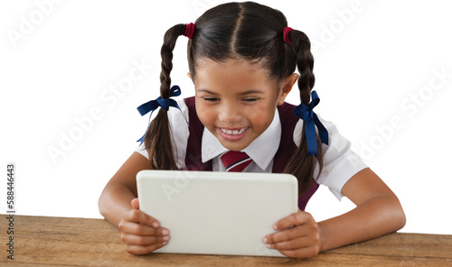 Schoolgirl using digital tablet at desk