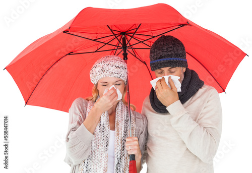 Ill couple sneezing in tissue while standing under umbrella photo