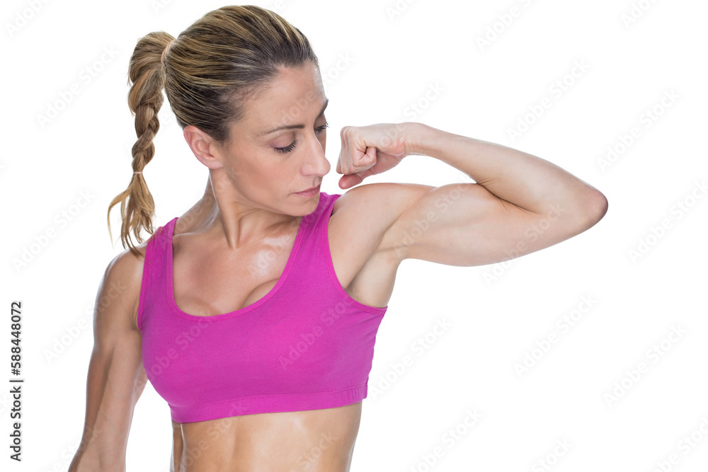 Female bodybuilder flexing bicep in pink sports bra Female bodybuilder flexing bicep in pink sports bra