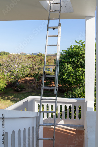 Unattendend ladder on a steep staircase, concept for a safety violation and unsafe conditions