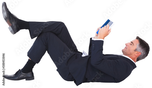 Businessman lying while reading book on white background