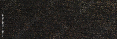 Shiny black background. Shimmering golden glitter closeup