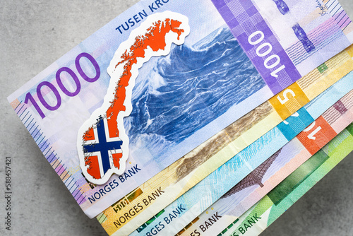 Foto Norwegian money on a gray table top all banknotes, Norway flag, business and fin