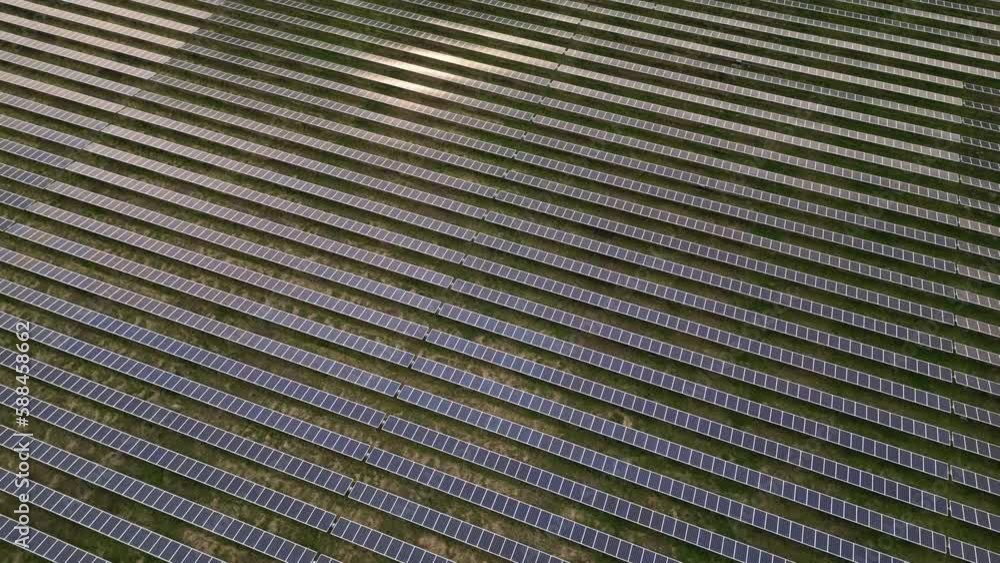 Ecology solar power station panels in the fields green energy at sunset landscape electrical innovation nature environment. Field of photovoltaic panels Ecology solar power station panels in the fields green energy at sunset landscape electrical innovation nature environment. Field of photovoltaic panels