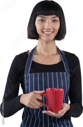 Smiling waitress holding cup of coffee against white background